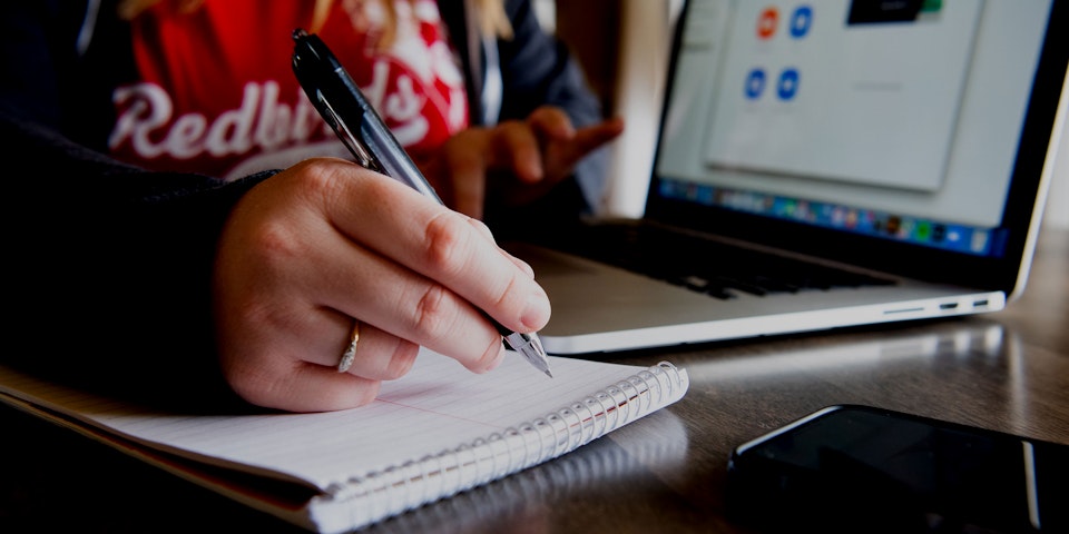 Female with laptop and notebook.
